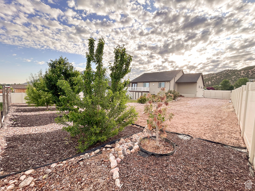 Rear view of house featuring a fenced backyard and stucco siding