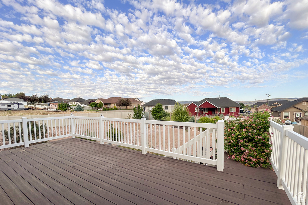 Wooden terrace featuring a residential view