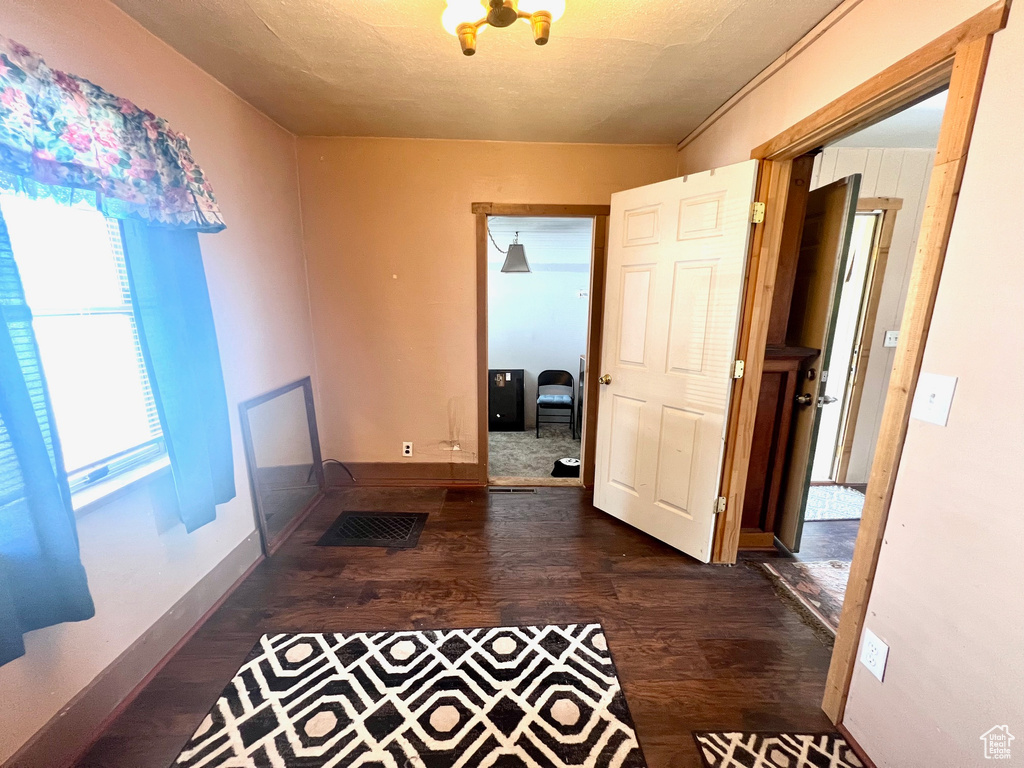 Hall featuring wood finished floors and baseboards