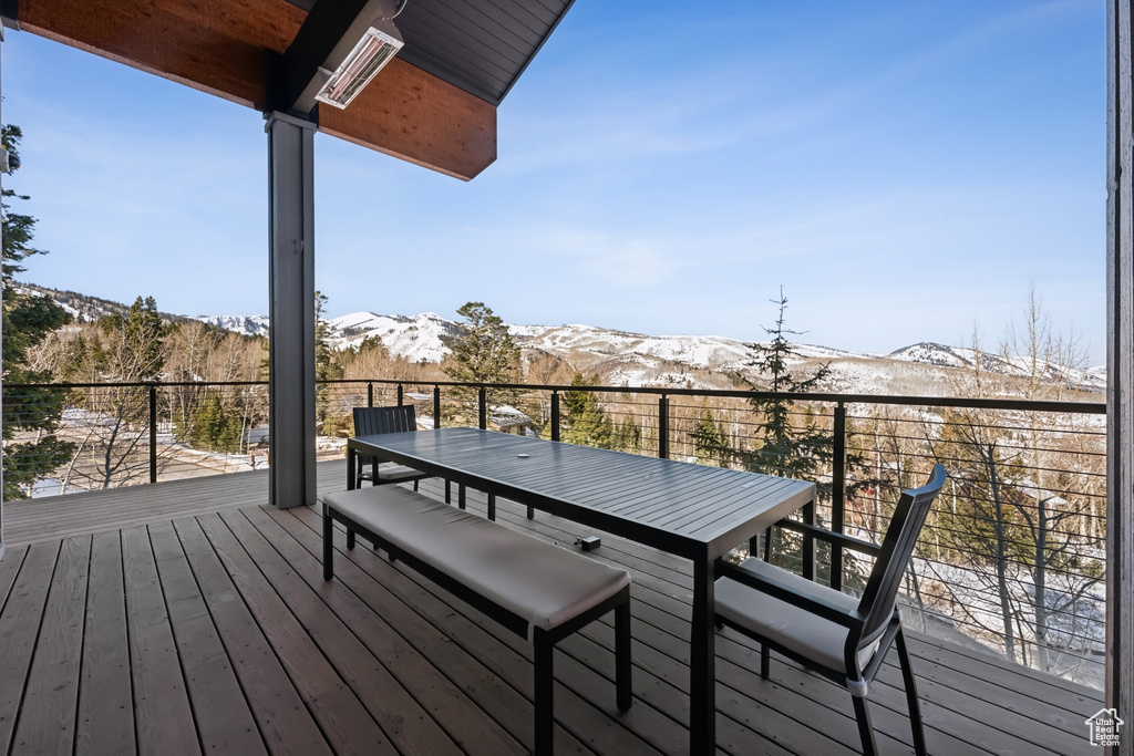 Deck with a mountain view and outdoor dining space