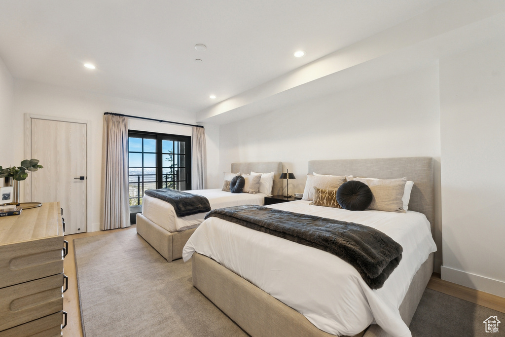 Bedroom featuring recessed lighting, access to exterior, light wood-type flooring, and baseboards