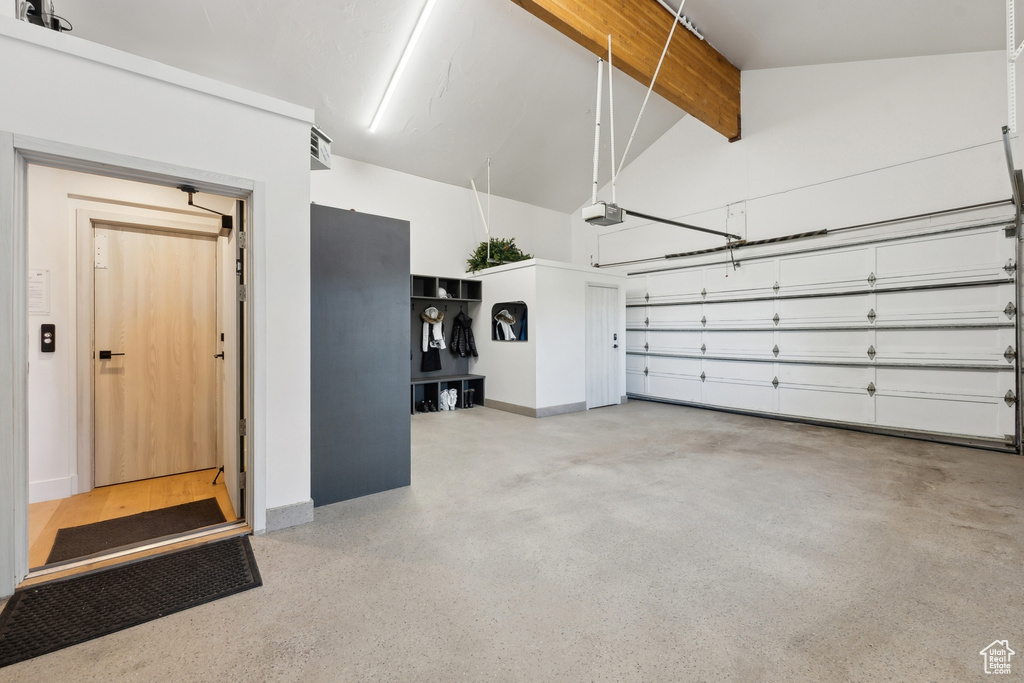 Garage with a garage door opener and baseboards