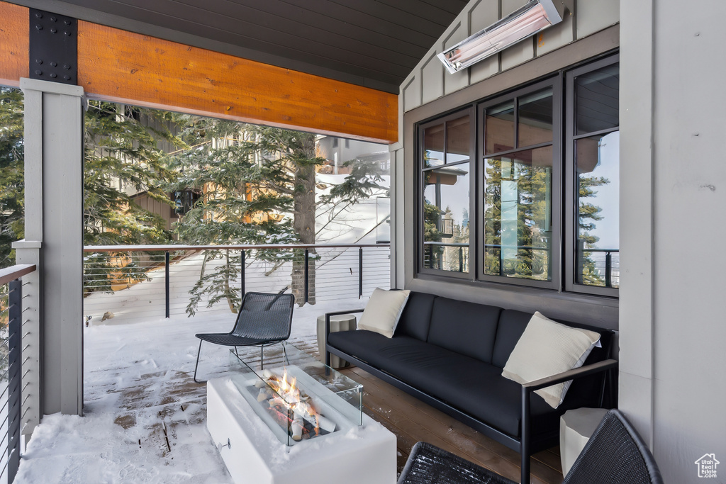 View of patio with an outdoor living space with a fire pit