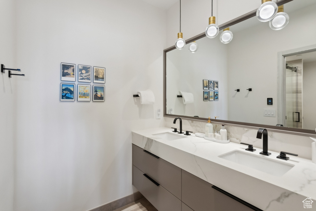 Bathroom with double vanity and baseboards