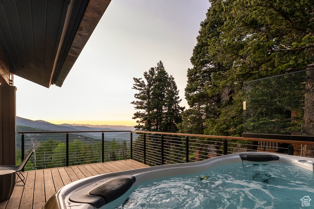 Deck at dusk featuring a mountain view
