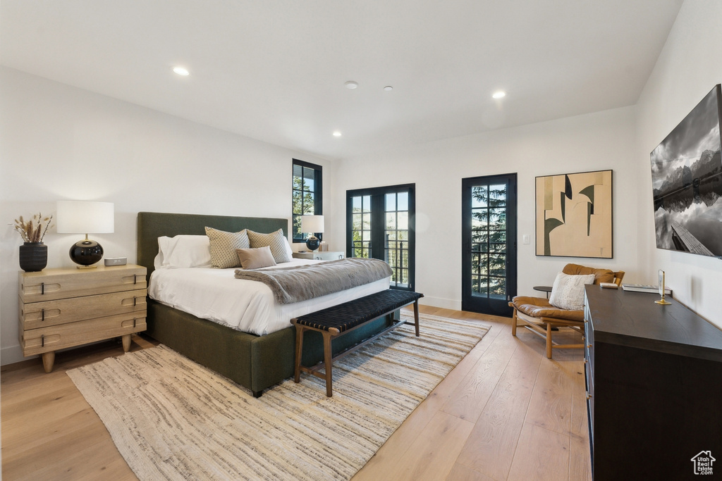 Bedroom featuring french doors, light wood-type flooring, recessed lighting, and baseboards