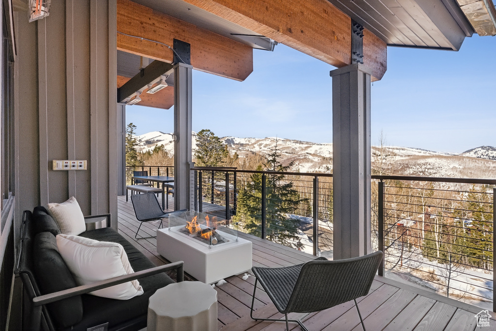 Deck featuring a fire pit and a mountain view