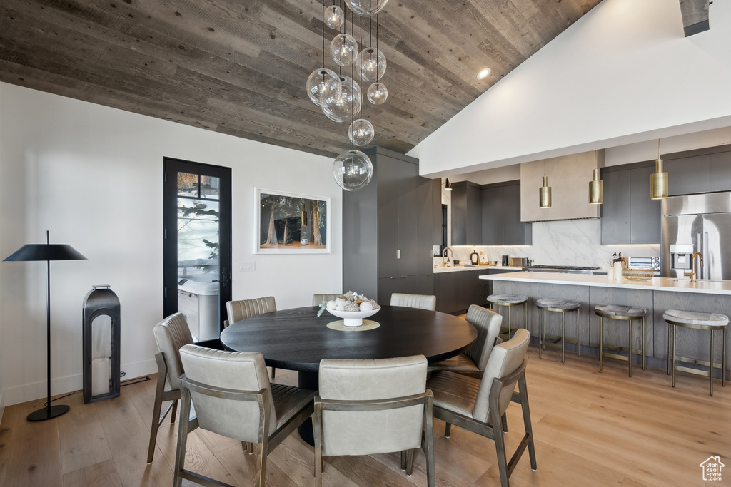 Dining space featuring wooden ceiling, light wood-style floors, recessed lighting, and high vaulted ceiling