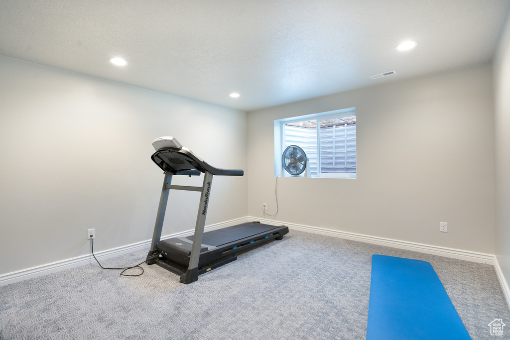 Workout area with carpet floors, baseboards, and recessed lighting