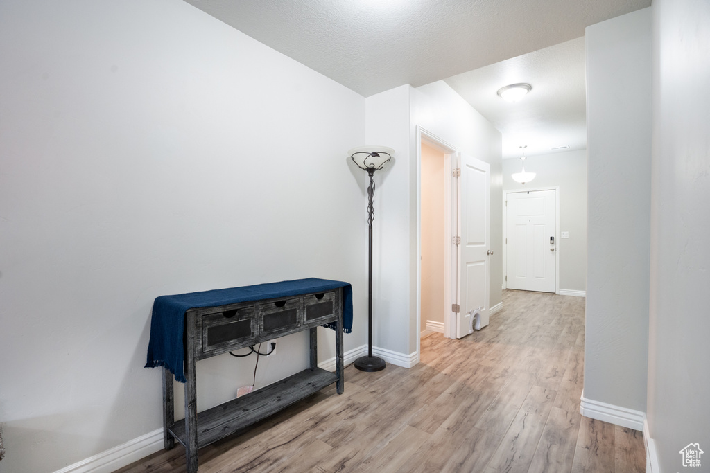 Hall featuring wood finished floors and baseboards