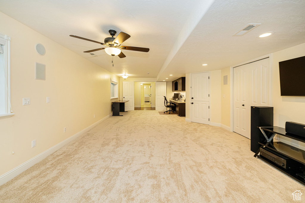 Unfurnished living room with light colored carpet, ceiling fan, recessed lighting, and baseboards