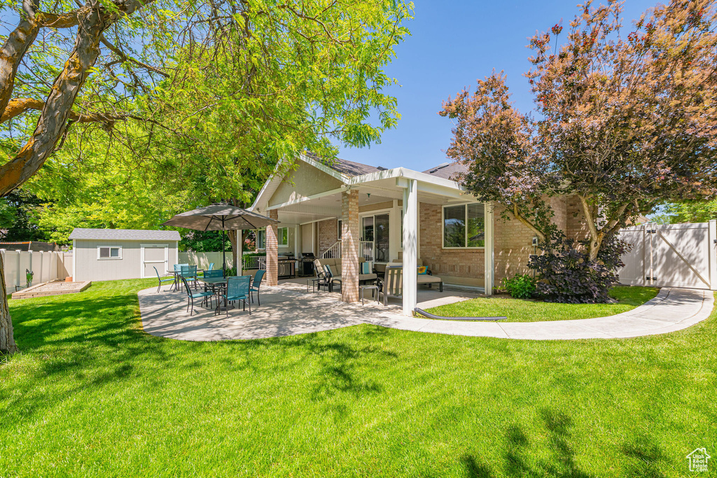 Back of house with brick siding and a patio area