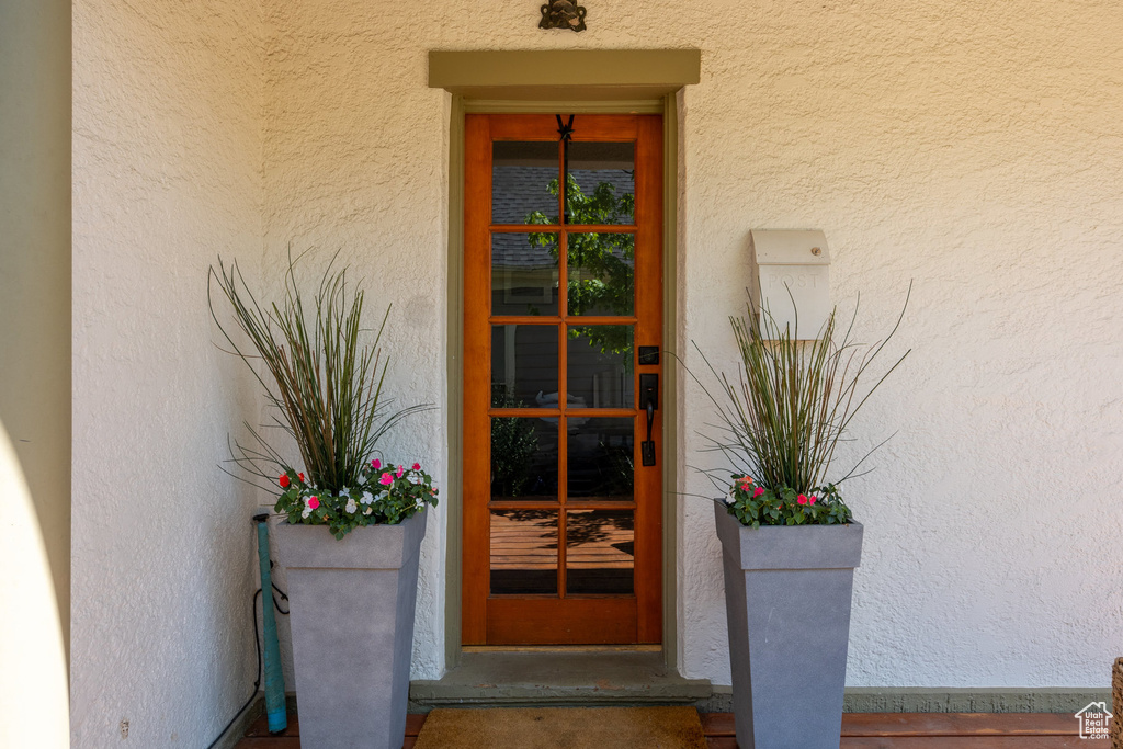 View of exterior entry featuring stucco siding