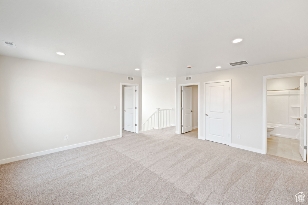 Spare room with light carpet, recessed lighting, and baseboards