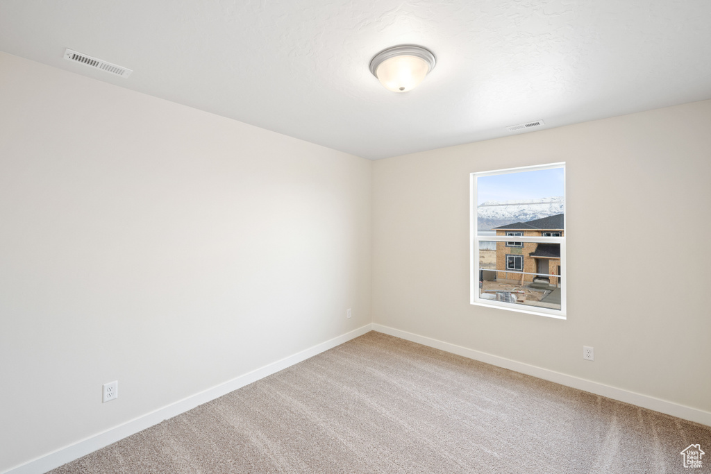 Spare room with baseboards and carpet floors