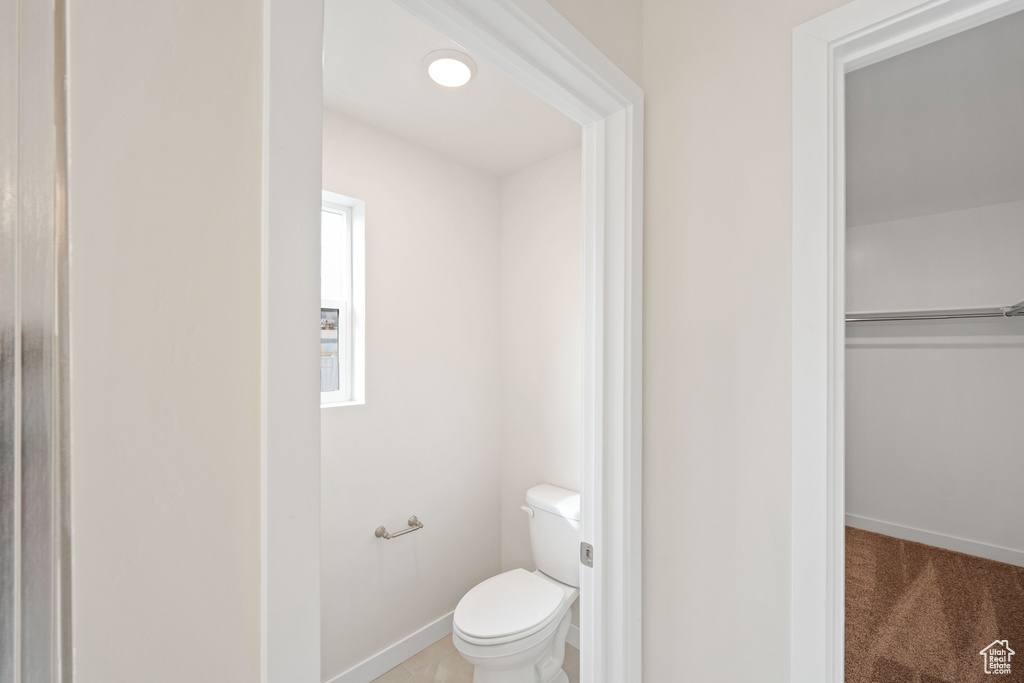 Bathroom featuring toilet and baseboards