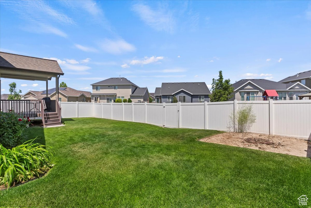 View of yard with a residential view and a wooden deck