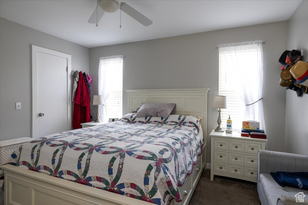 Bedroom featuring dark colored carpet and a ceiling fan