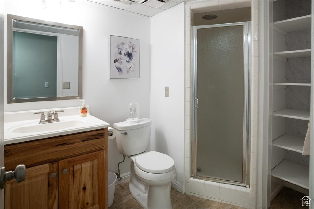 Bathroom with vanity, a stall shower, and toilet