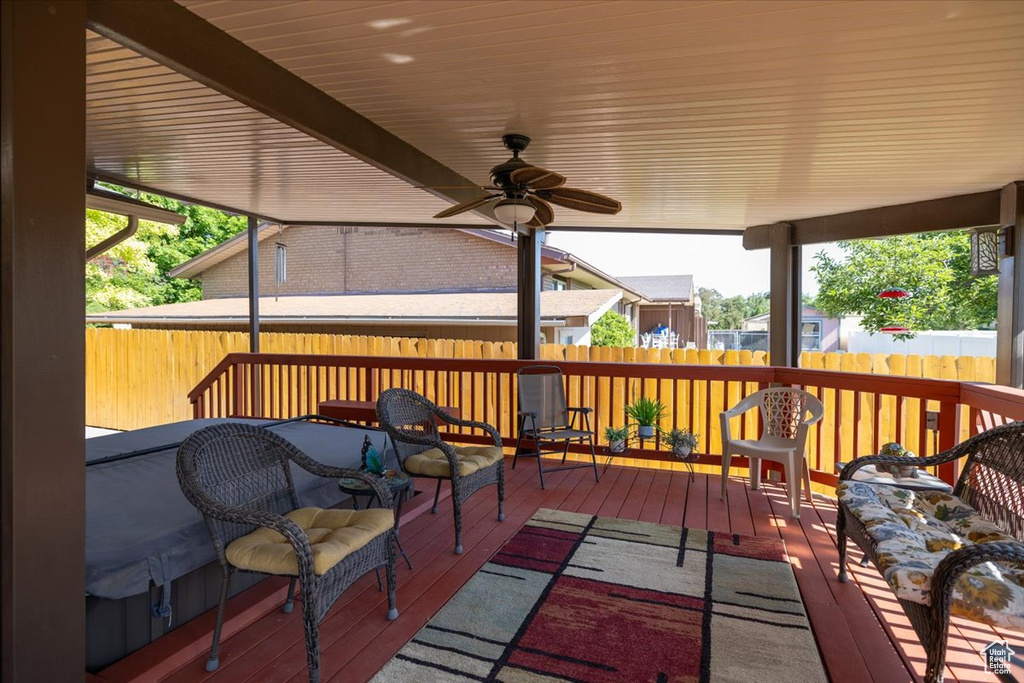 Deck with a fenced backyard and ceiling fan