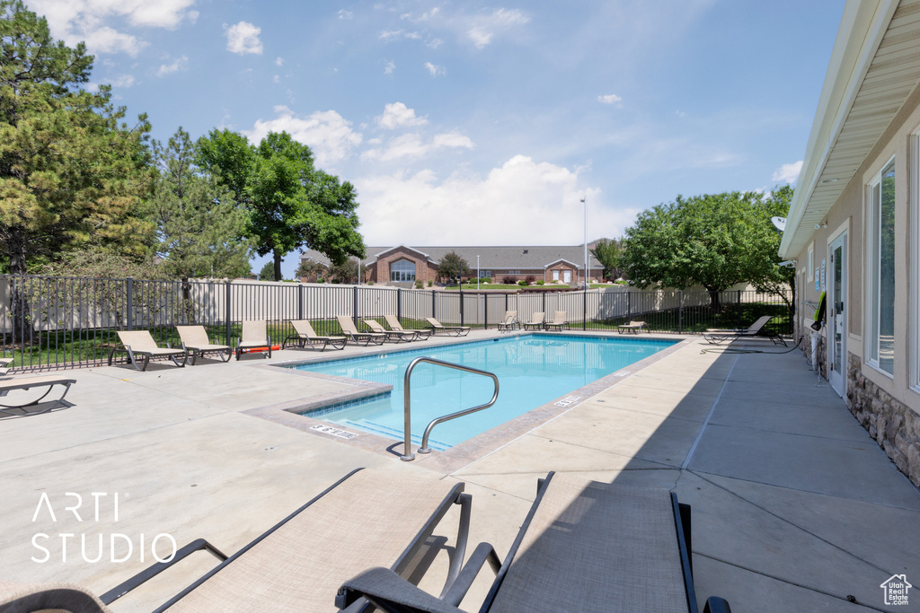 Community pool with a patio