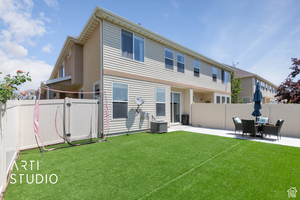 Rear view of property with a patio area and central AC