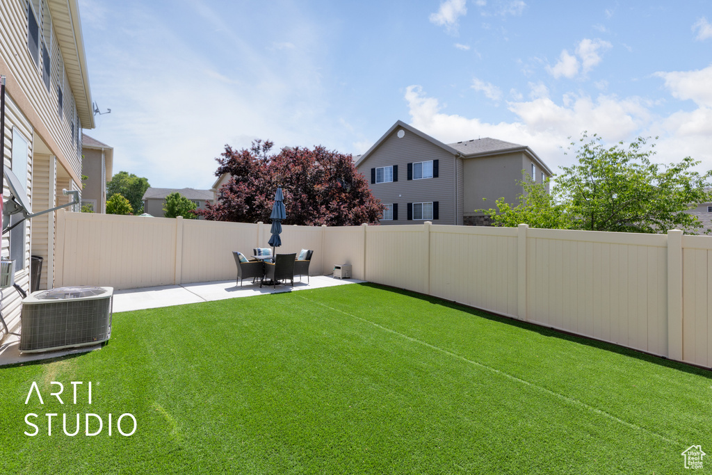 View of yard featuring cooling unit and a patio area