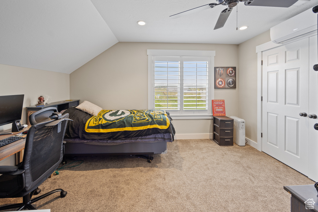 Bedroom featuring an AC wall unit, carpet flooring, vaulted ceiling, ceiling fan, and baseboards