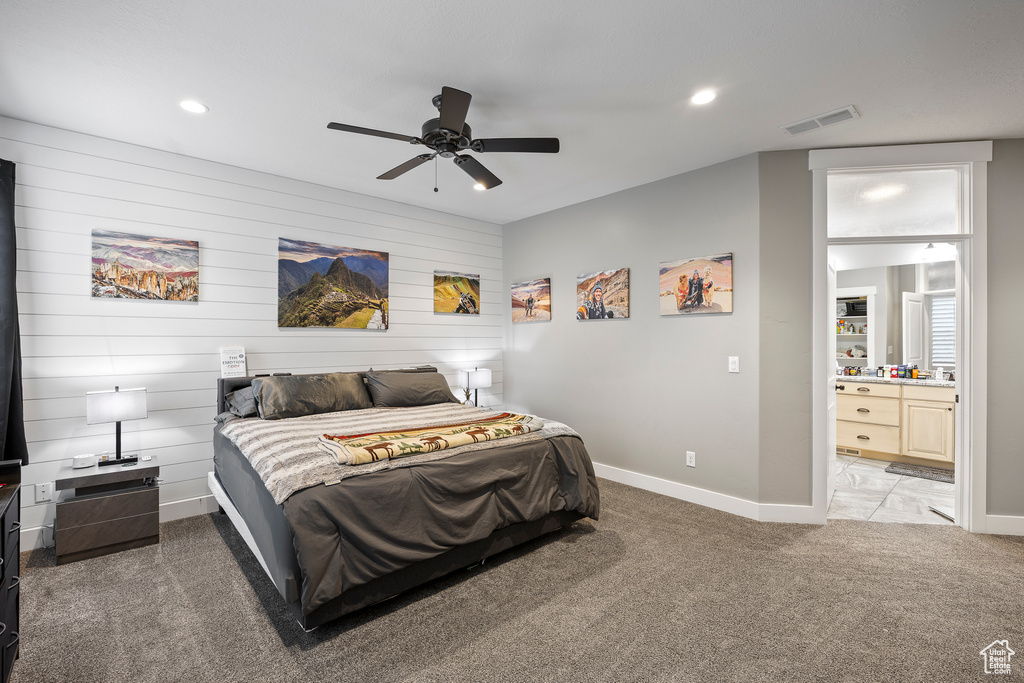 Bedroom with light carpet, baseboards, recessed lighting, ensuite bath, and a ceiling fan