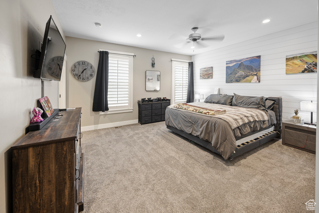 Carpeted bedroom featuring baseboards, ceiling fan, and recessed lighting
