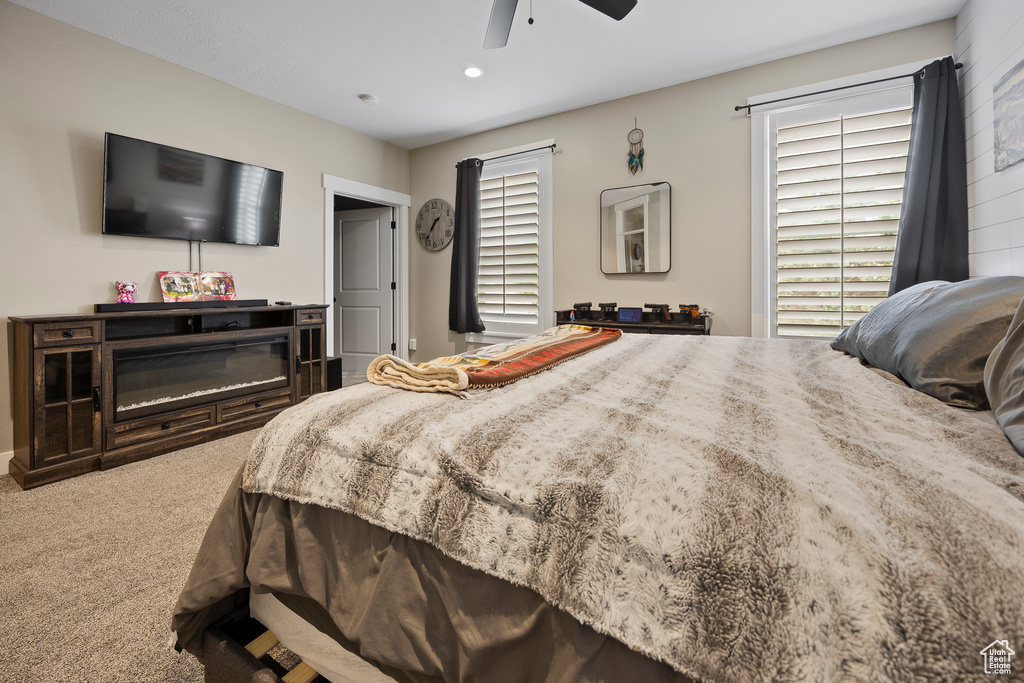 Carpeted bedroom featuring ceiling fan and recessed lighting