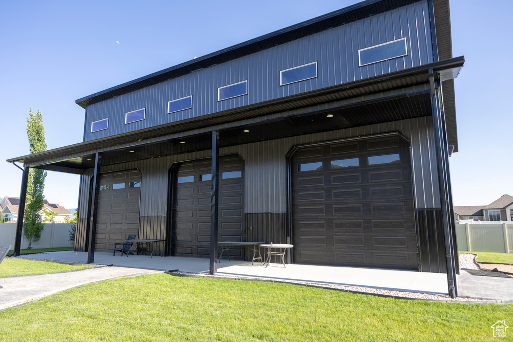 Rear view of property with an attached garage