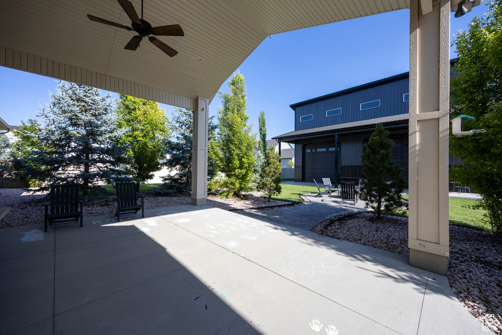 View of patio / terrace featuring ceiling fan and a garage