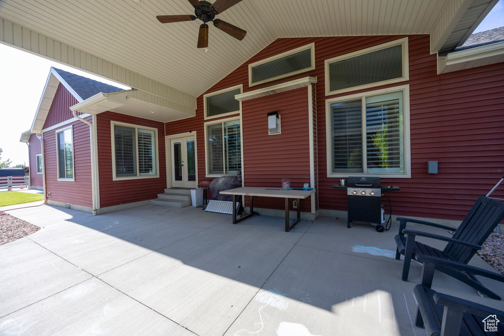 View of patio featuring entry steps, a ceiling fan, area for grilling, and french doors