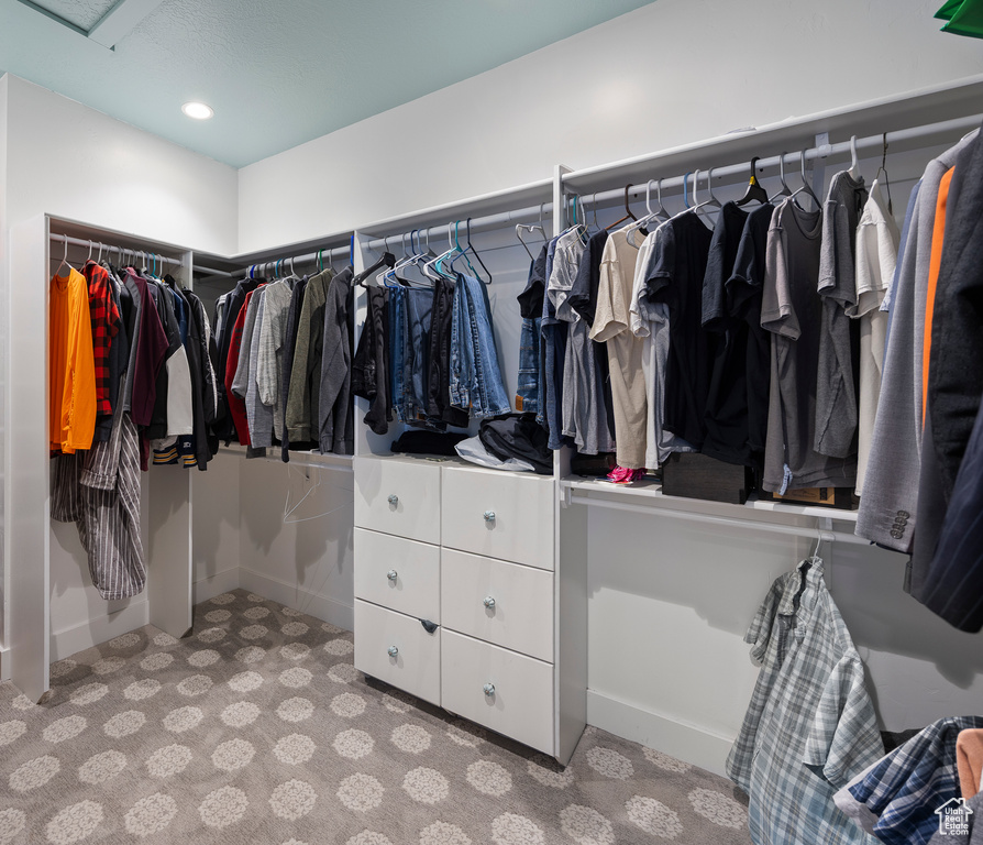 Spacious closet with carpet floors