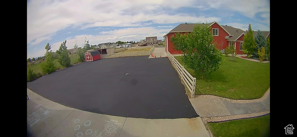 View of asphalt driveway featuring a residential view