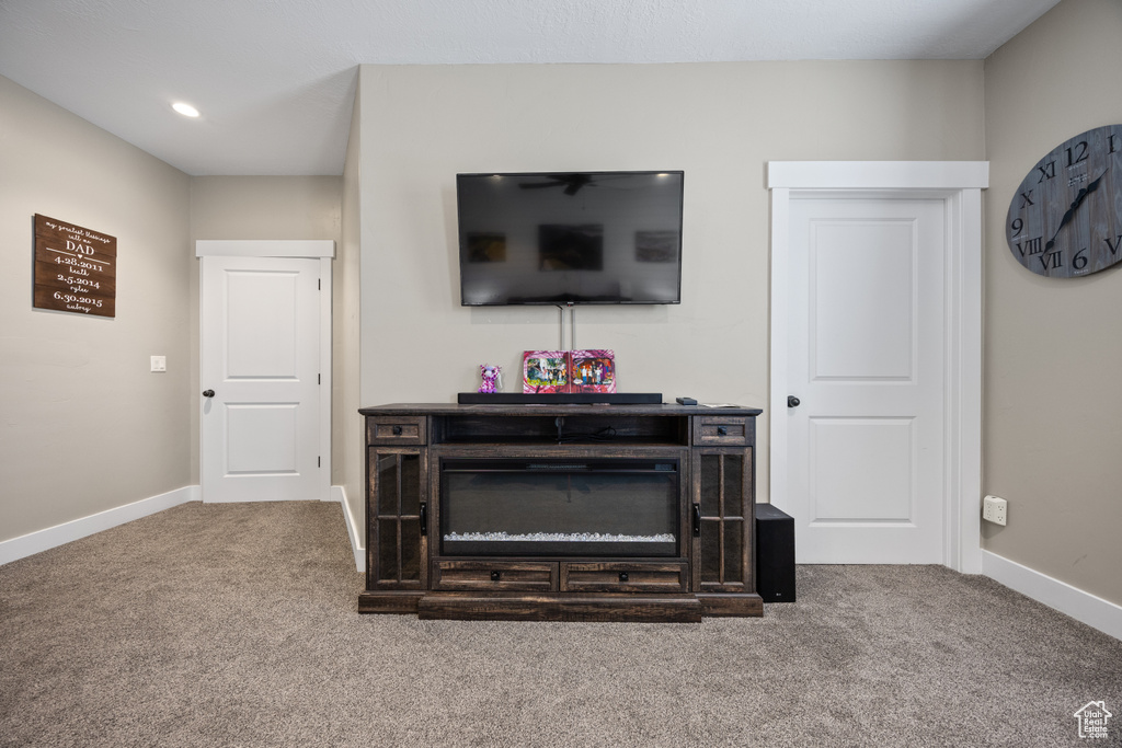 Carpeted living room featuring baseboards