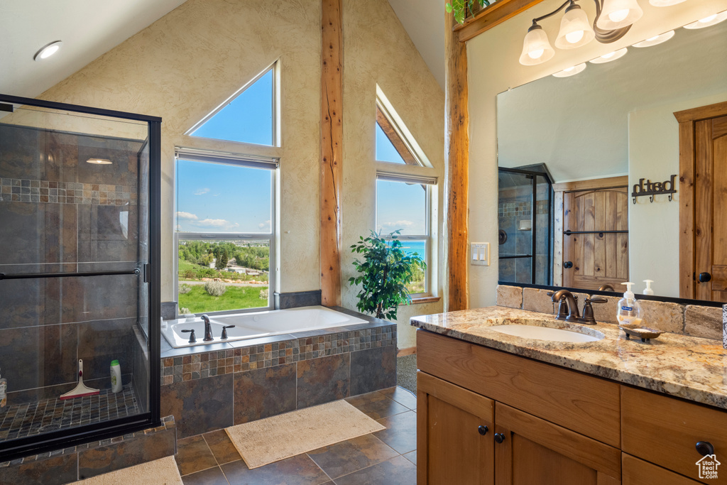 Full bathroom with vanity, a shower stall, and a bath