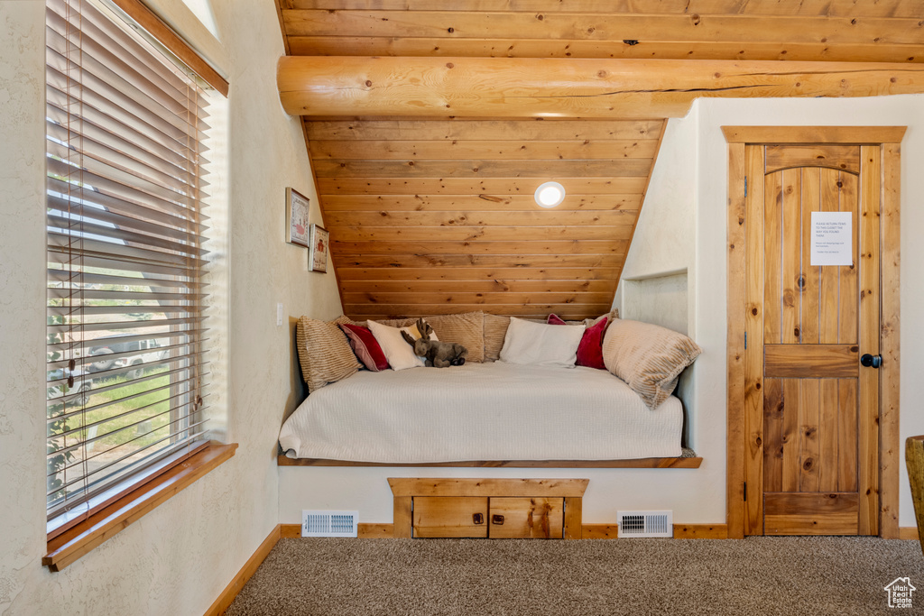 Bedroom featuring carpet and baseboards