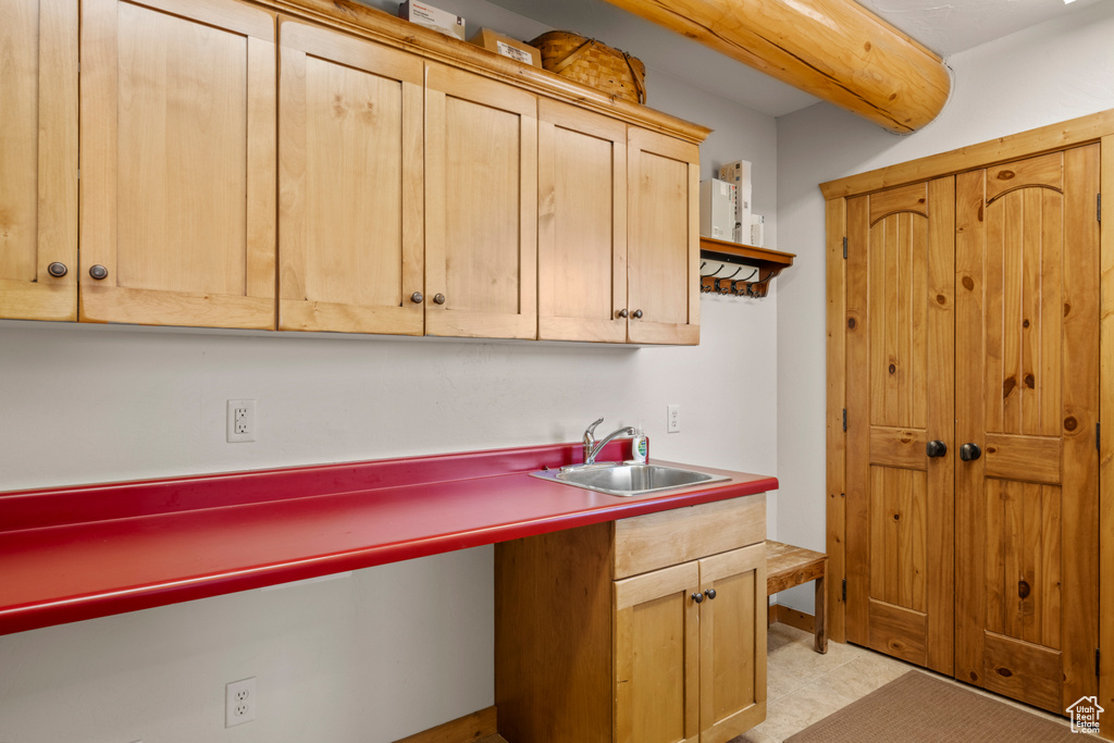 Kitchen with a sink and light brown cabinets