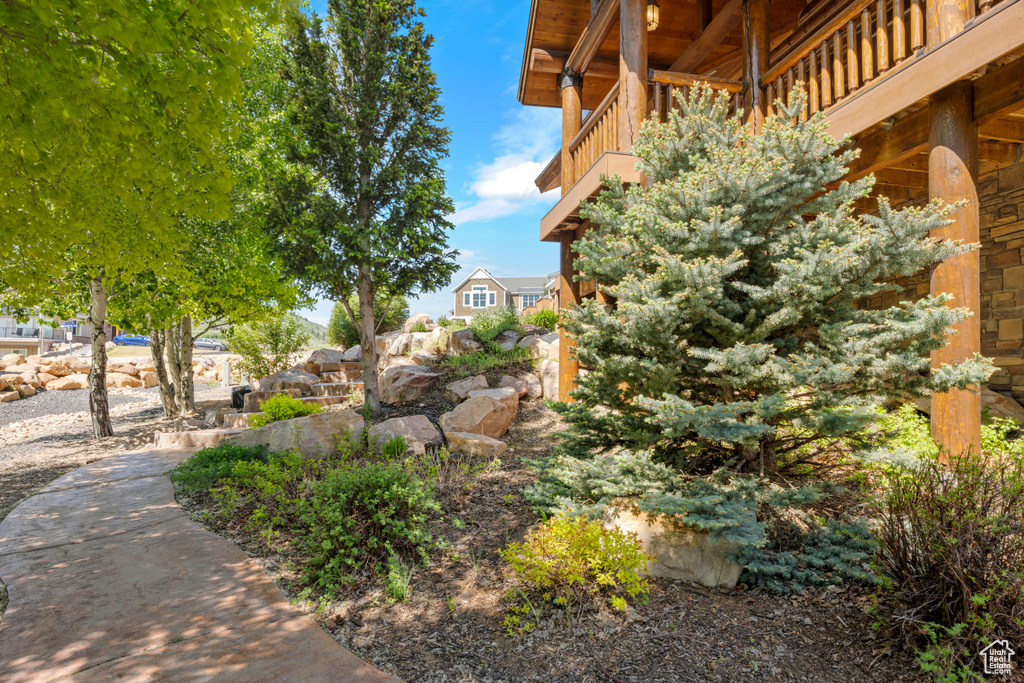 View of yard with a balcony