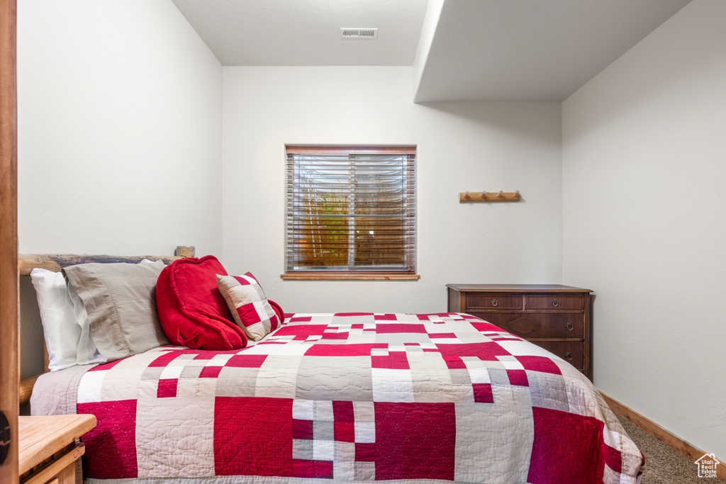 Bedroom featuring baseboards and carpet