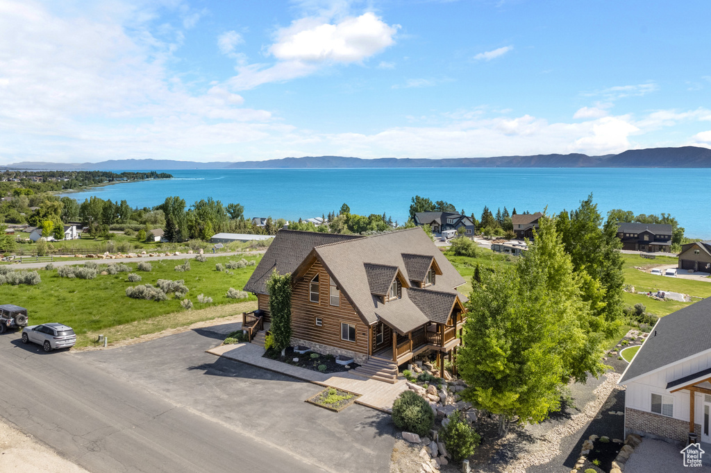 Aerial view of property and surrounding area with a water and mountain view