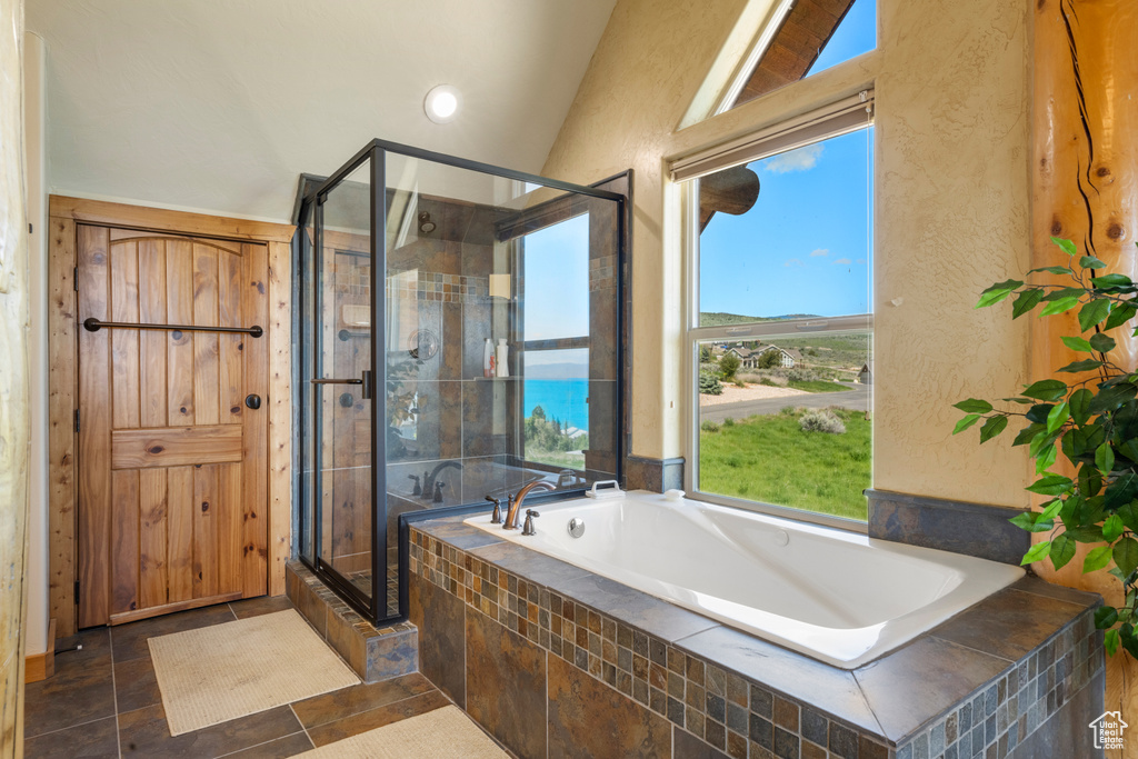Full bathroom featuring a garden tub, a shower stall, vaulted ceiling, recessed lighting, and a textured wall