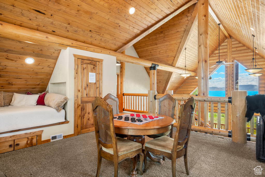 Carpeted dining area featuring a water view, vaulted ceiling, wooden ceiling, and recessed lighting