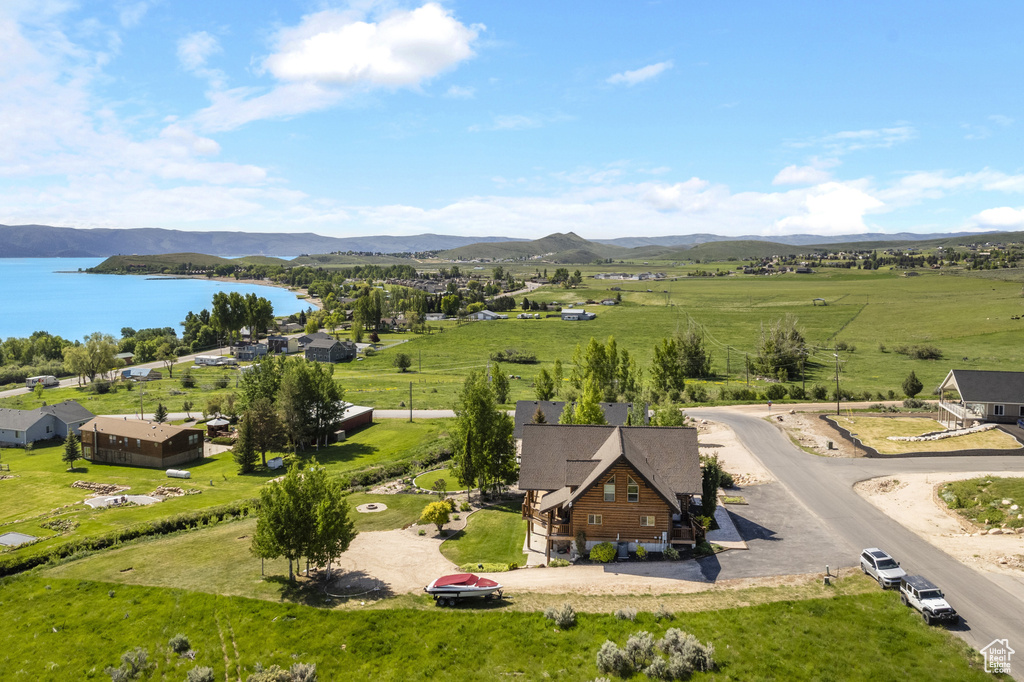 Aerial view of property and surrounding area featuring a water and mountain view