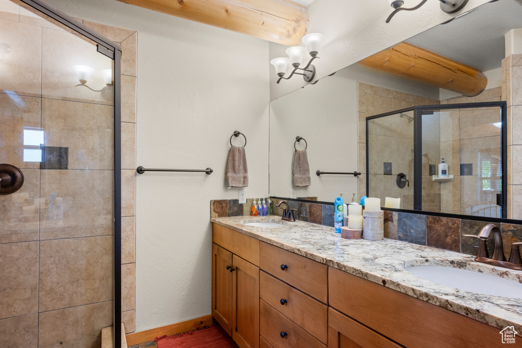Bathroom featuring double vanity and a stall shower