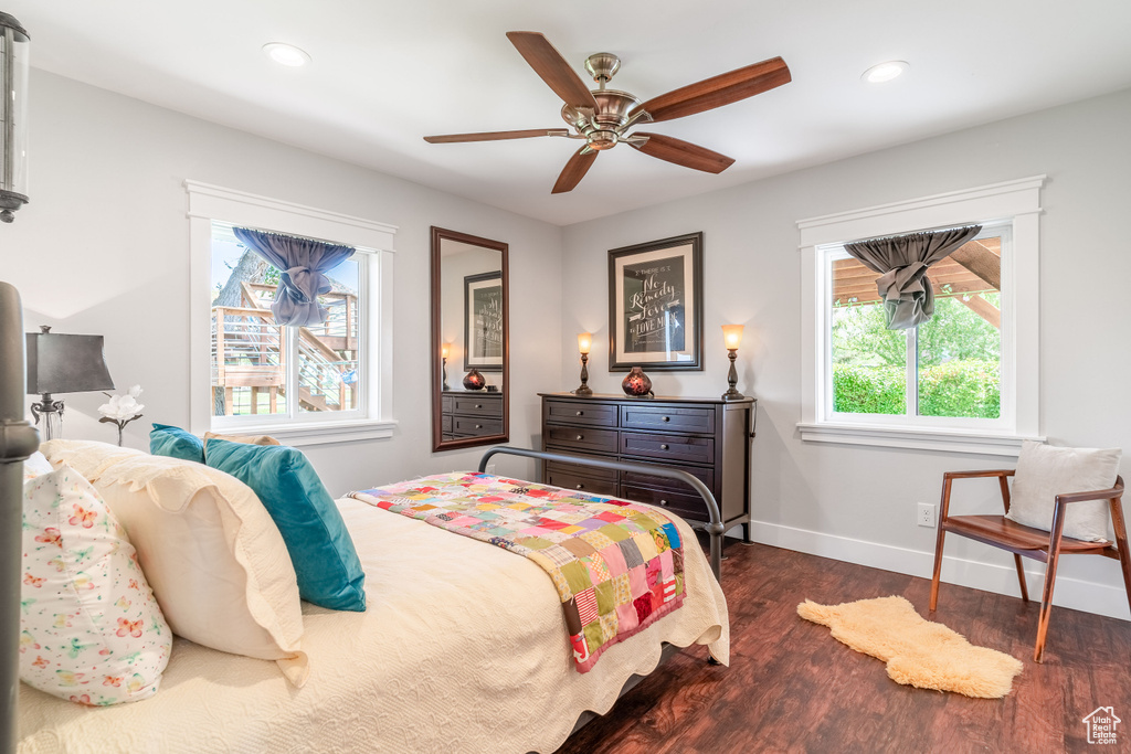 Bedroom with dark wood finished floors, baseboards, recessed lighting, and a ceiling fan