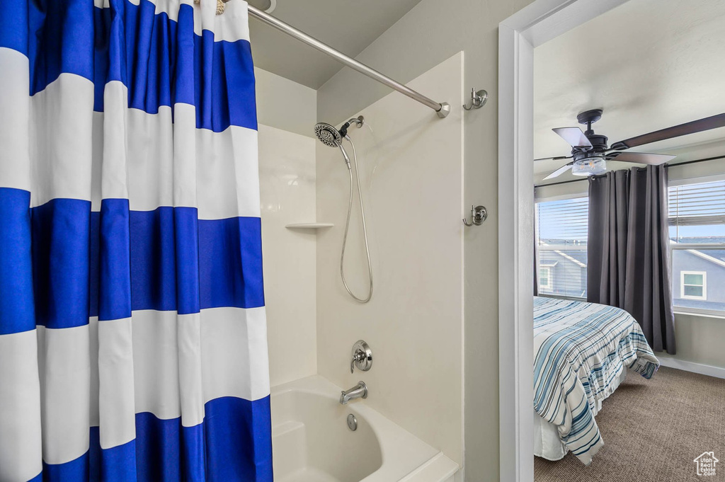 Bathroom featuring shower / tub combo with curtain, ceiling fan, and ensuite bathroom
