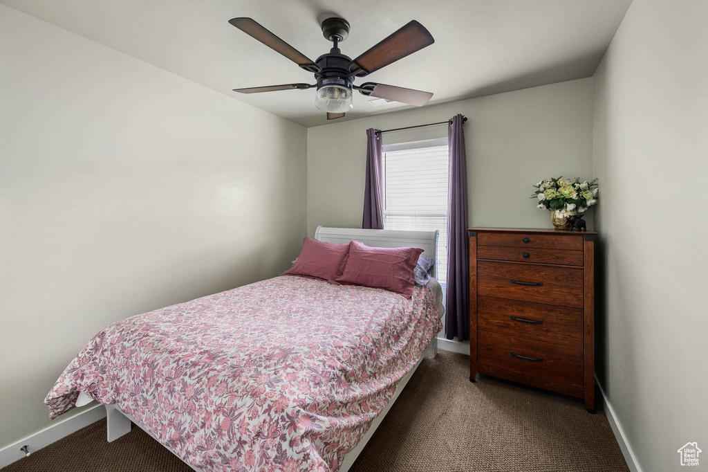 Carpeted bedroom with baseboards and ceiling fan